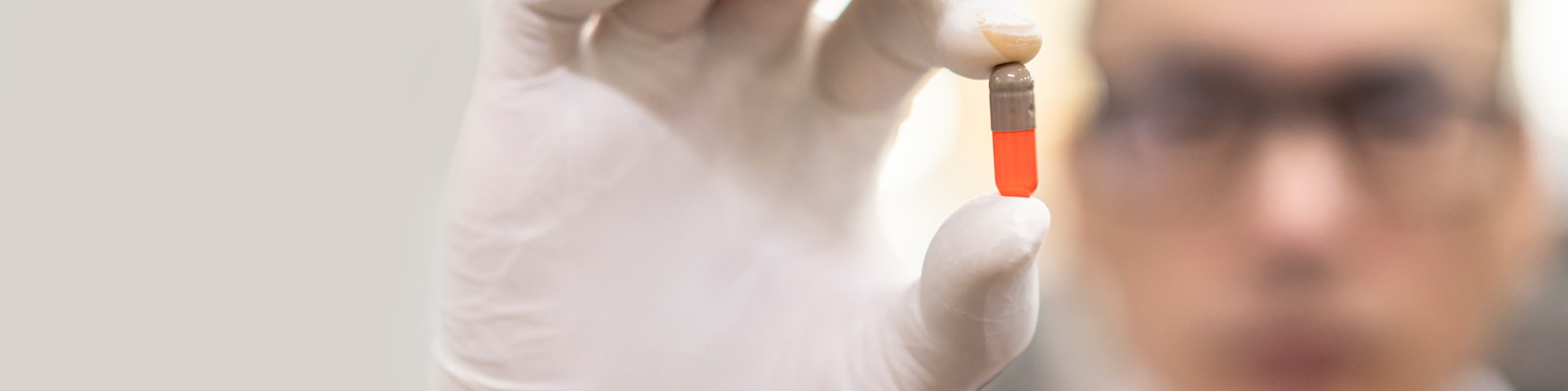 Scientist holding pill