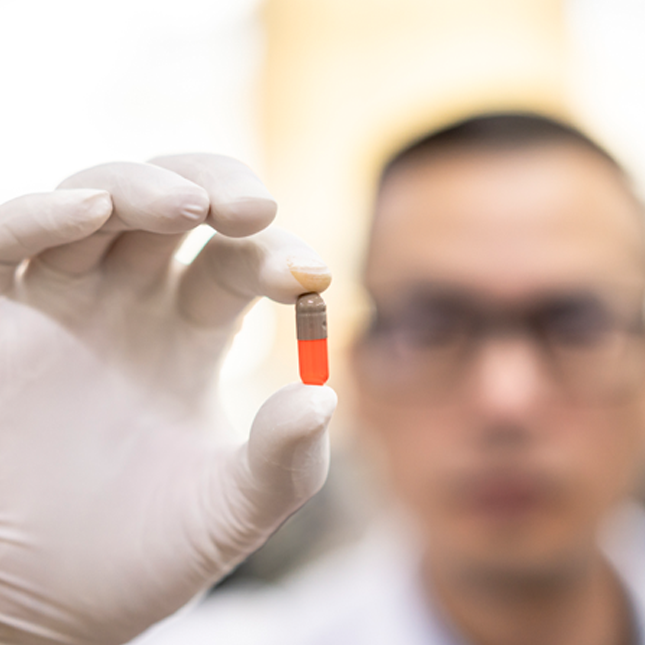 Scientist holding pill