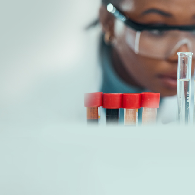 Scientist looking at test tubes in lab