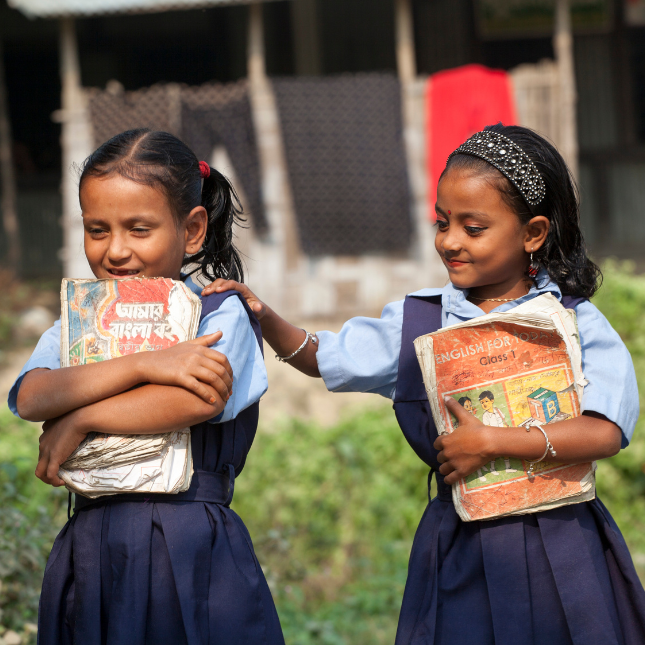 School girls walking from school with books