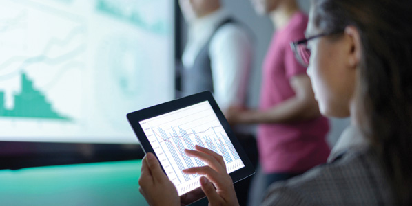 Woman scientist with iPad looking at data