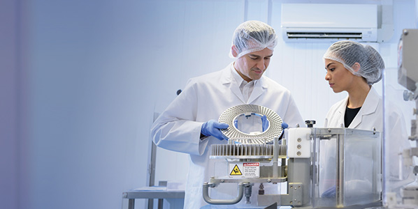 two scientist working with lab equipment