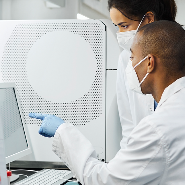 Scientists looking at a computer