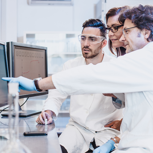 Scientists looking at a computer