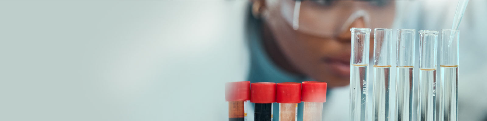 Scientist looking at test tubes in lab